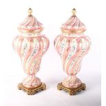 A pair of Paris porcelain vases and covers, the spiral fluted bodies with floral and gilt decoration