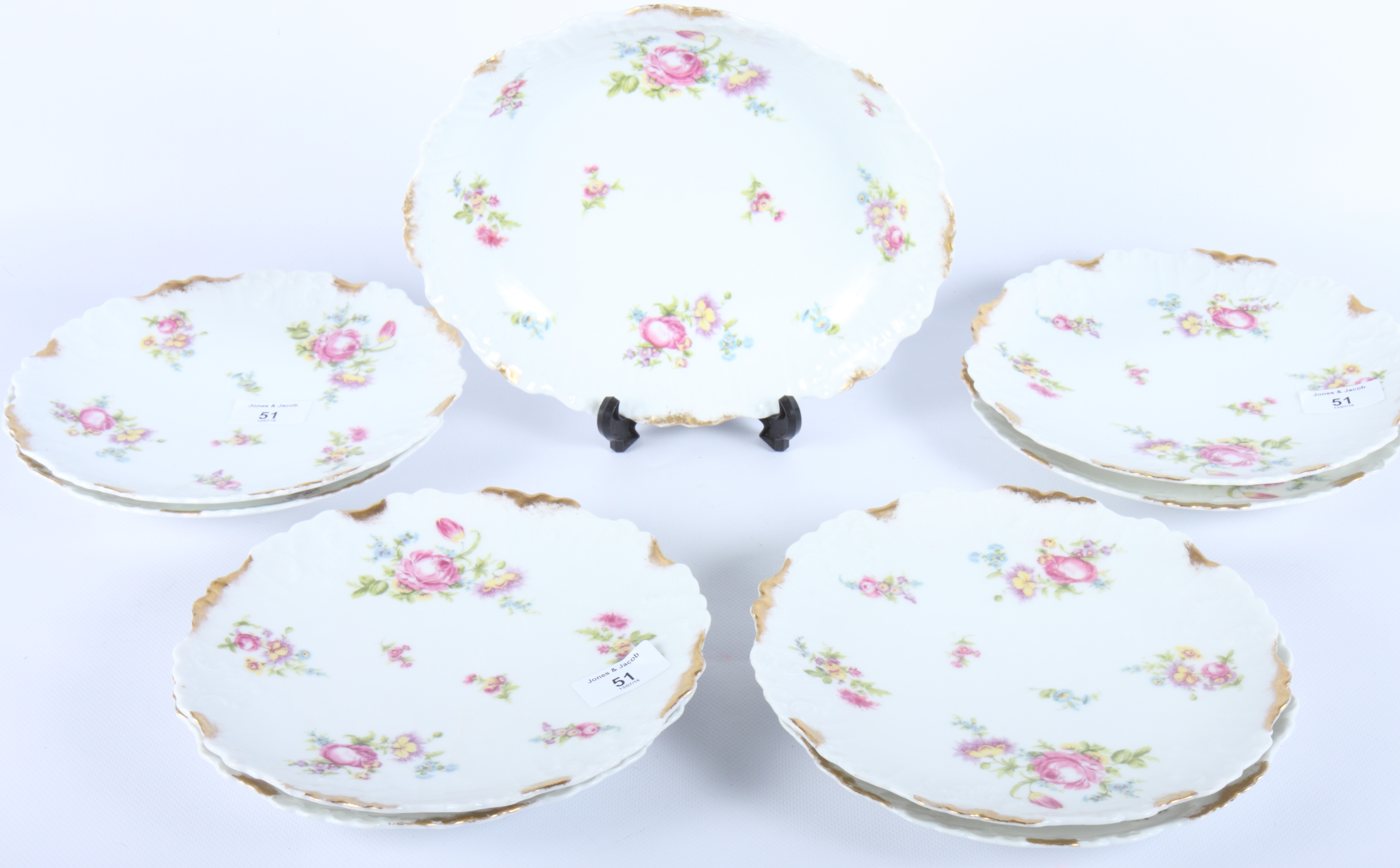 A Limoges porcelain floral and gilt decorated dessert service comprising a serving dish and eight