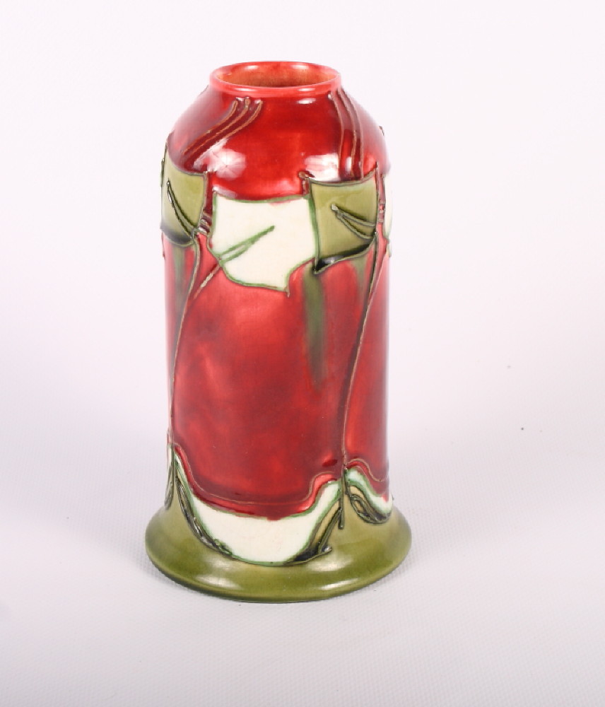 A Minton Secessionist design vase decorated stylised flowers in red and green (small chip to lip),