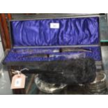 A pair of silver plated fish servers with horn handles, in fitted case, and a black ostrich