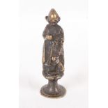 A 19th Century bronzed desk seal formed as a Dutch girl with a doll, 2 1/2" high