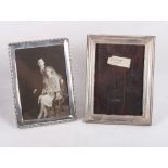 Two silver rectangular photograph frames