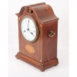 An Edwardian mahogany and shell paterae inlaid shape top mantel clock with white enamel dial and