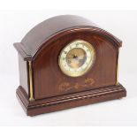 An Edwardian mahogany and inlaid arch top mantel clock with brass flanking columns, 10 1/2" high