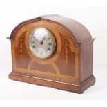 An early 20th Century walnut and inlaid mantel clock with silvered dial, 11" high