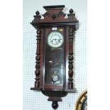 A Victorian wall clock in polished as mahogany case decorated split turned pilasters