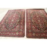 A pair of Persian Kirman design rugs with all-over floral design on a dark blue ground and multi-