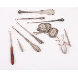 A collection of silver handled and other buttonhooks and shoe horns, etc