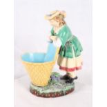 A Minton majolica sweetmeat basket in the form of a lady leaning on a basket, 9 1/2" high (