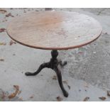 A Georgian faded mahogany circular tilt top occasional table, on turned column and tripod splay