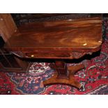 A mahogany fold-over top card table carved acanthus, on square column support and quadriform base,