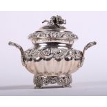 A continental silver two-handled pot and cover with embossed foliate decoration and cast scrolled