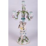 A 19th Century Dresden porcelain three-branch table candelabra, Venus and Cupid figures, 20" high (