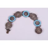 A silver and blue guilloche enamelled bracelet with alternate roundels decorated Tudor rose and