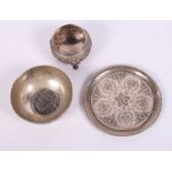 A Persian silver engraved pin dish, a similar bowl mounted coin and an Indian white metal salt, 6.