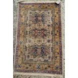 A Persian tribal rug decorated three star medallions on a sand ground, 37" x 23" approx