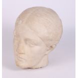 An antique carved marble portrait head of a classical woman with her hair in a bun, 9" high