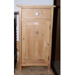 A stripped pine bedside cabinet, fitted one drawer over cupboard, 17" wide