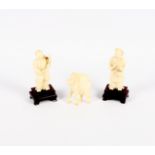 A pair of early 20th Century Chinese carved ivory figures, 3" high, on hardwood stands, and a