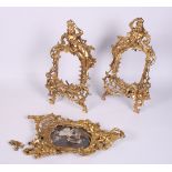 A pair of gilt metal scroll work photograph frames with crowned women, 14" high, and a companion