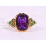 An 18ct gold, amethyst and emerald dress ring, size N, 6.2g