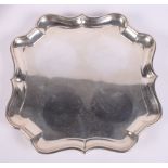 A silver pie crust waiter raised on four supports, 14.1oz troy approx