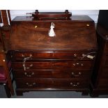 A Georgian mahogany fall front bureau with fitted interior, tooled lined writing surface, over