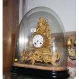 A 19th Century French mantel clock in ornate gilt metal case with figure surmount under glass