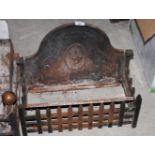 A cast iron basket grate with armorial, 19" wide