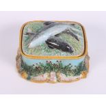 A majolica ware sardine box and cover, 6 1/2" wide, and a continental porcelain floral basket, 6 1/