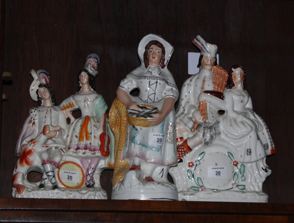 A 19th Century Staffordshire watch group, 13 1/2" high, a similar group, travelling players, 13"