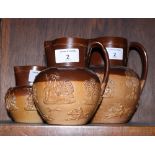 A set of three Doulton Lambeth stoneware hunting jugs with sprigged decoration, in sizes, largest