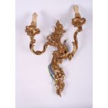 A pair of Rococo design three-branch gilt metal wall lights and a similar pair of two-branch wall