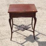 A late 19th Century mahogany work table with padded compartment, blind fretted carved frieze, on