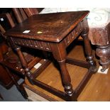 An oak joint stool of 17th Century design, on turned and stretchered supports, 18" wide