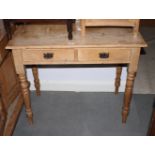 A late 19th Century stripped pine washstand, fitted two drawers, on turned and tapering supports,