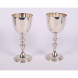 A pair of modern silver goblets by Garrard & Co, the stems and feet cast fruiting vines, 12.6oz troy