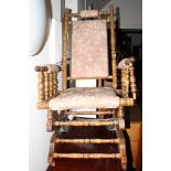 An American rocking chair, upholstered in a pink floral brocade