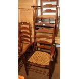 A pair of Gimson design fruitwood and mahogany elbow chairs
