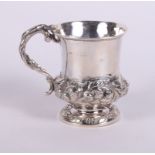 A Georgian silver christening mug with entwined serpent handle and embossed foliate decoration, 4.