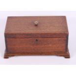 A late Georgian mahogany three-division tea caddy, on bracket supports, 10" wide