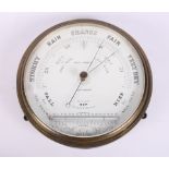 A brass cased aneroid barometer and thermometer by W & H Trimnell, 9" dia