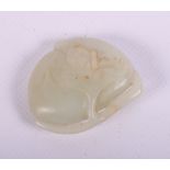 A Chinese pale celadon green jade carving of a peach, 2" wide