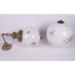 Two enamelled glass globular ceiling light pendants, one with brass fittings