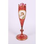 A late 19th Century bohemian ruby glass spill vase with scrolled foliate gilt decoration and