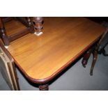 A late 19th Century oak dining table with centre leaf, on turned and reeded supports, 40" x 40"