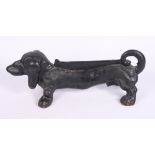 A cast iron dachshund boot scraper and a dachshund head bottle opener