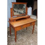 A late 19th Century Arts & Crafts oak dressing table with mirror and jewel drawers over two