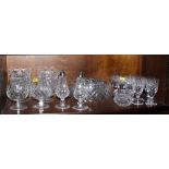 A set of eight cut glass sherries, six cut glass fruit bowls, two cut glass vases, a cut glass bowl,