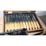 A set of twelve silver plated fish knives and forks with ivory handles, in mahogany canteen